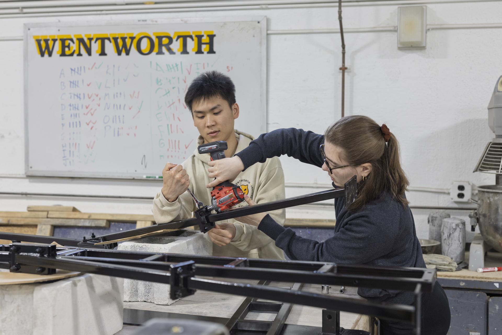 Two students working with equipment
