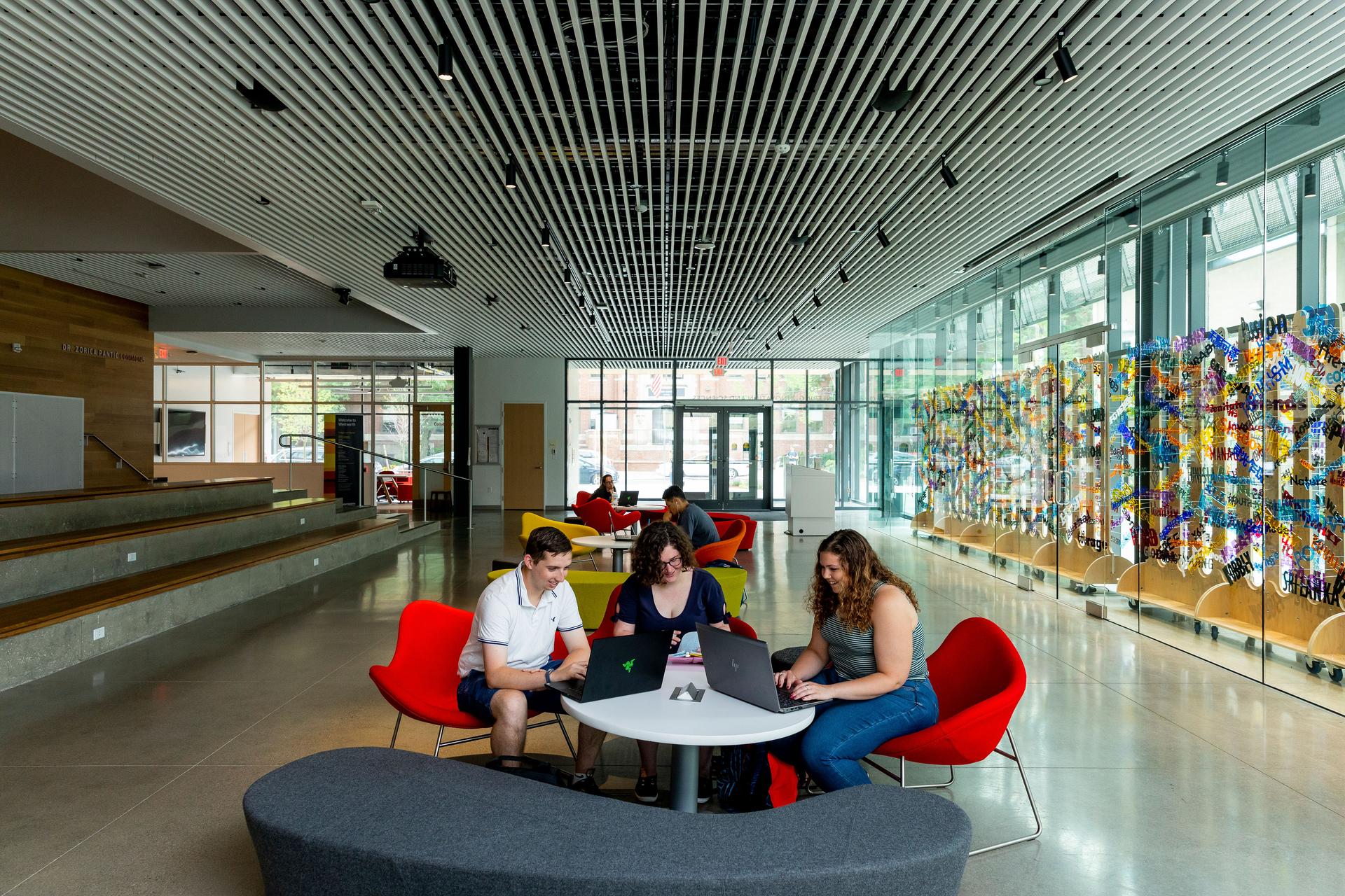 Three students working at a table