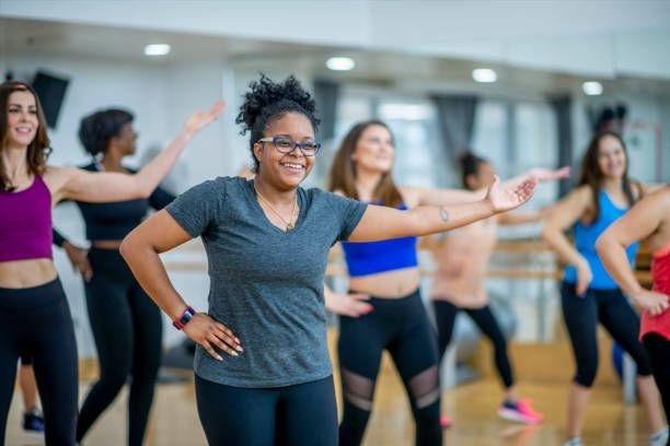 A group of women in a gym exercising.