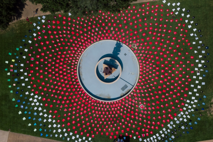 1,001 shirts laid out in front of Butler Plaza. The shirts come in ranges of red to white.