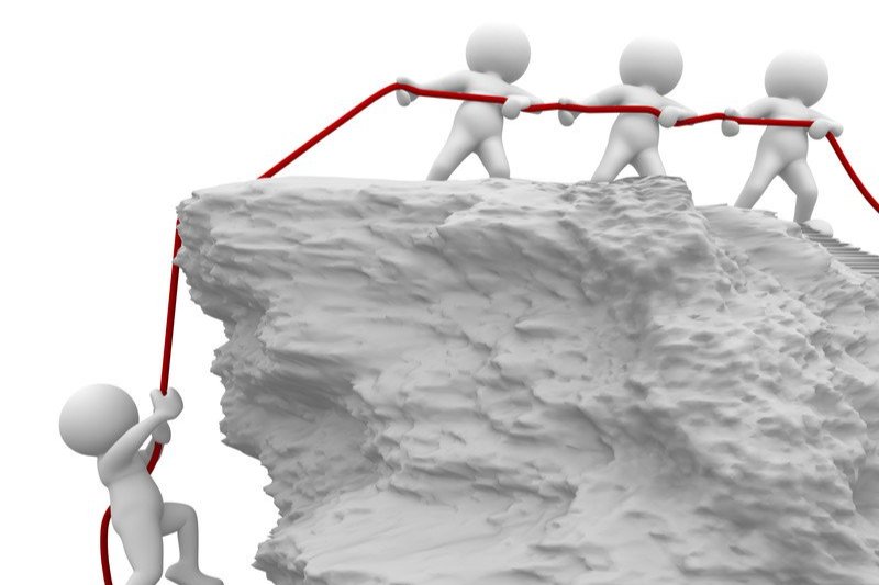 a group of people pulling a rope