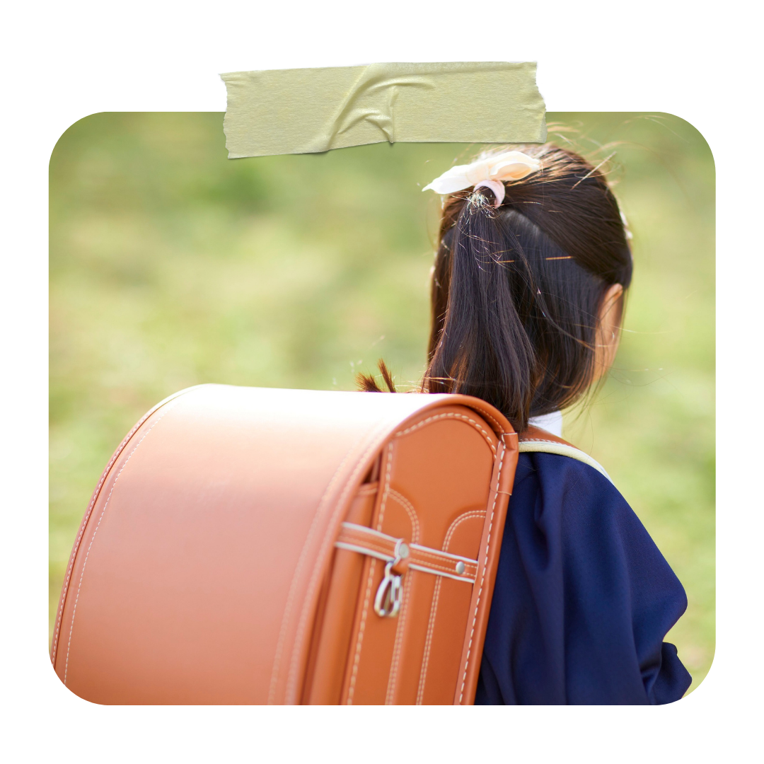 Japanese school girl carrying a camel brown randoseru backpack