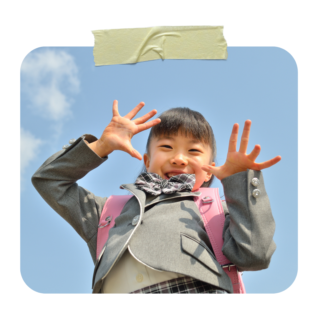 Japanese school child wearing a pink randoseru with safety features